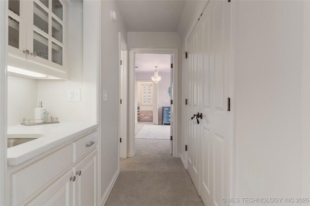 corridor with light colored carpet