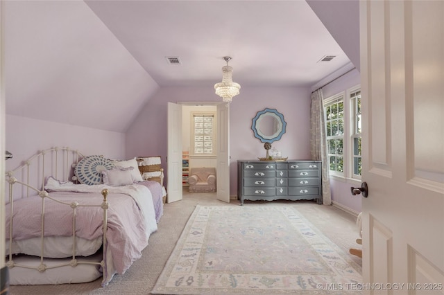 bedroom with light colored carpet, lofted ceiling, and multiple windows