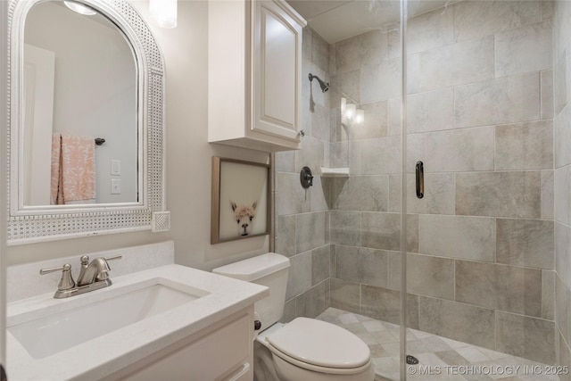 bathroom with vanity, toilet, and an enclosed shower