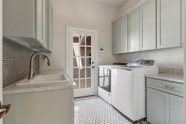 laundry room featuring sink, cabinets, and independent washer and dryer