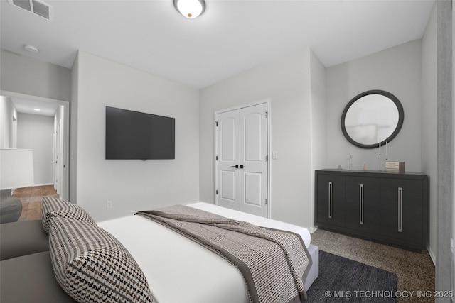 bedroom featuring dark colored carpet