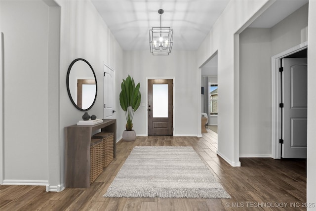 entrance foyer featuring a notable chandelier and dark wood-type flooring