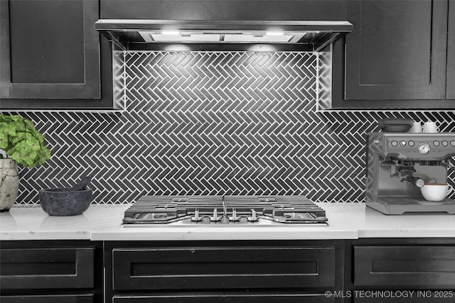 kitchen featuring extractor fan, decorative backsplash, and stainless steel gas cooktop