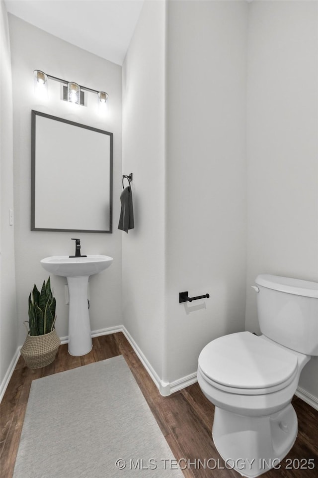 bathroom featuring toilet and hardwood / wood-style floors