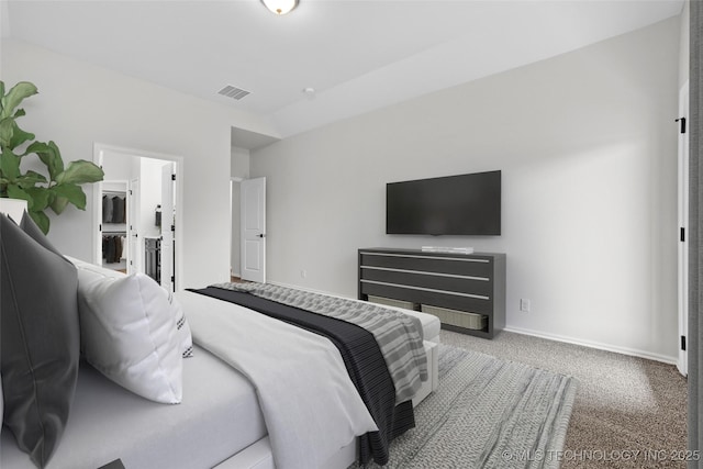 bedroom featuring carpet and connected bathroom