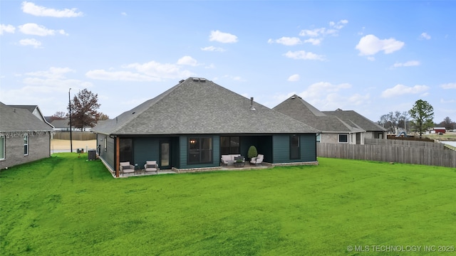 rear view of house featuring a patio, a yard, and central AC