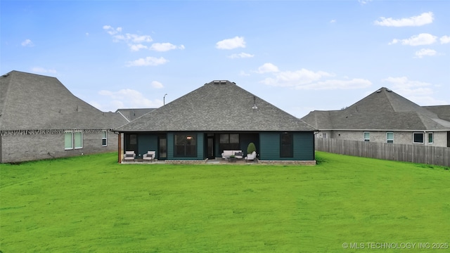 back of property featuring a patio area and a lawn