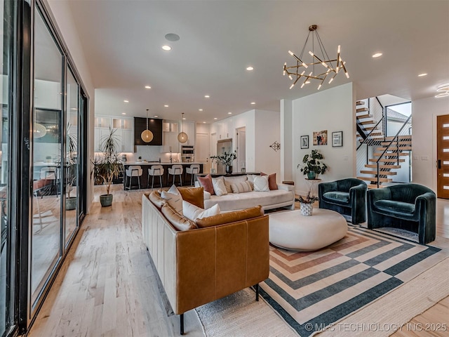 living room featuring light hardwood / wood-style floors and an inviting chandelier