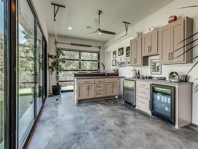 kitchen featuring ceiling fan, sink, beverage cooler, concrete flooring, and fridge