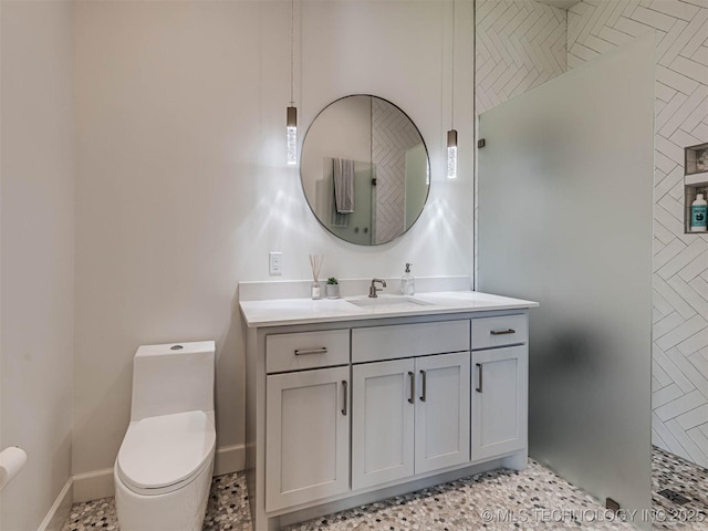 bathroom featuring vanity, toilet, and a shower