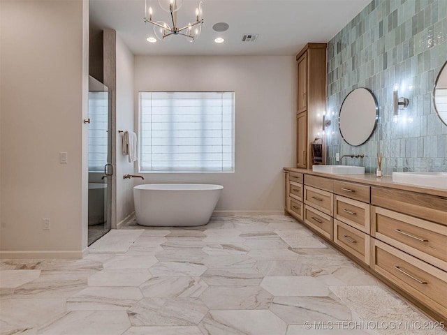 bathroom featuring vanity, tile walls, independent shower and bath, and a chandelier