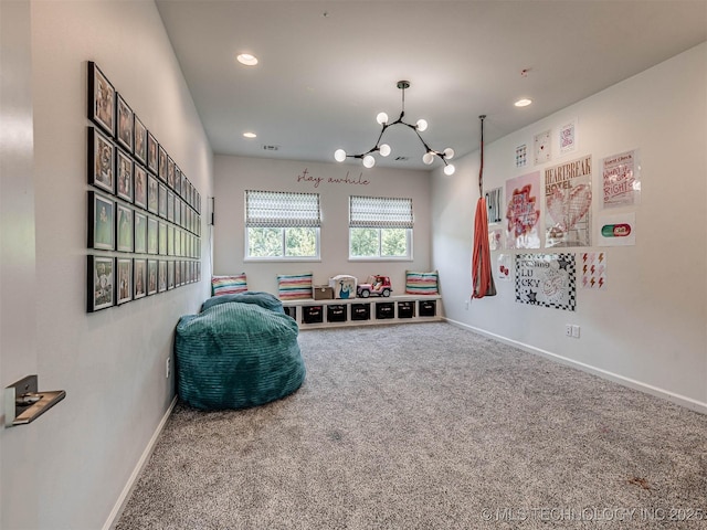 rec room with carpet and an inviting chandelier