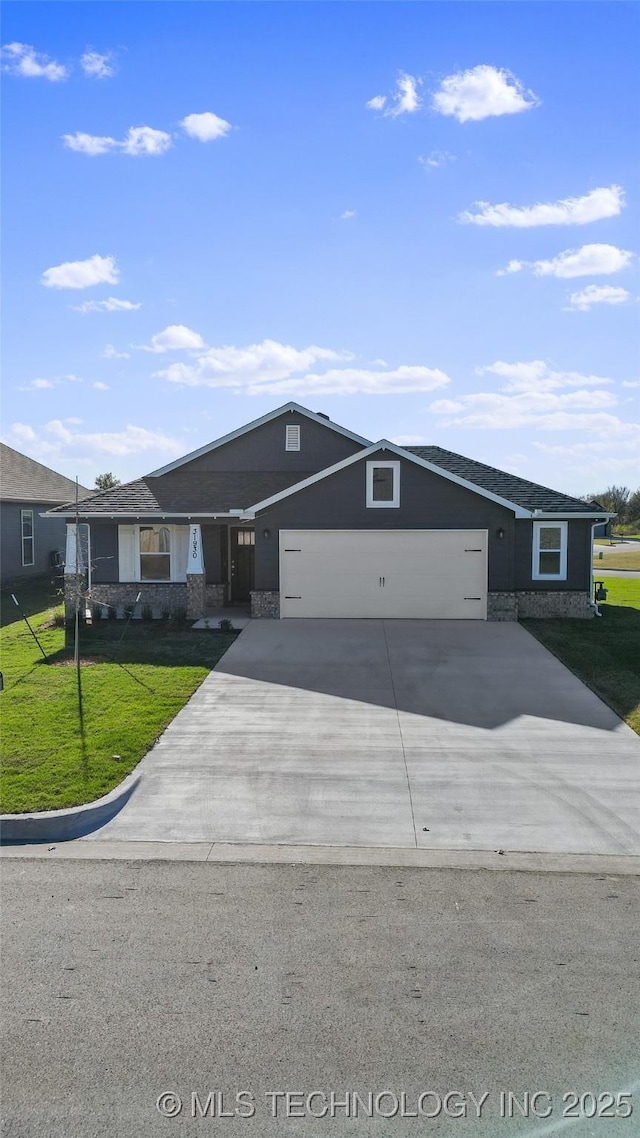 single story home featuring a garage and a front lawn