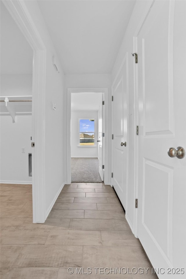 hallway with light wood-type flooring