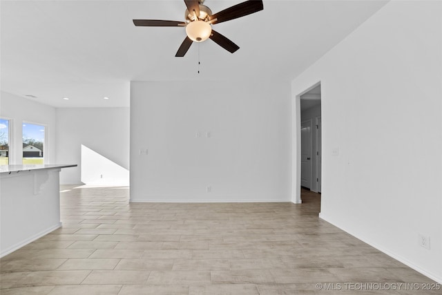 unfurnished room featuring ceiling fan