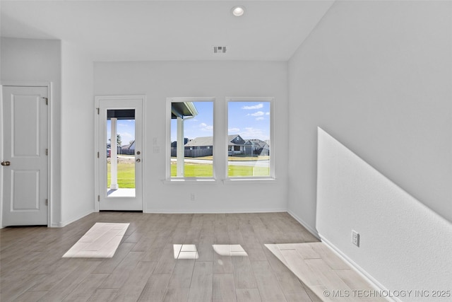 spare room with light hardwood / wood-style flooring