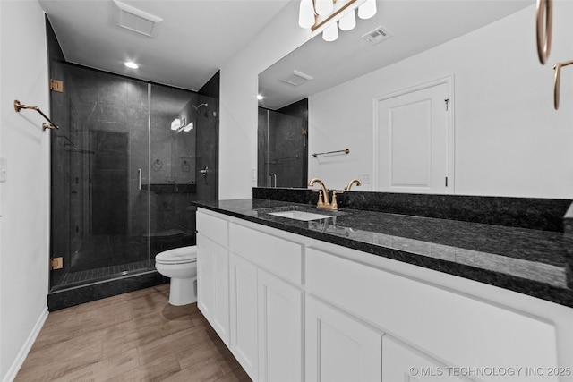 bathroom featuring walk in shower, vanity, and toilet