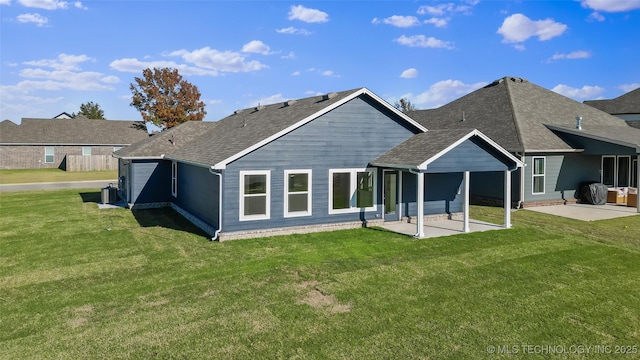 back of house with cooling unit, a patio area, and a lawn