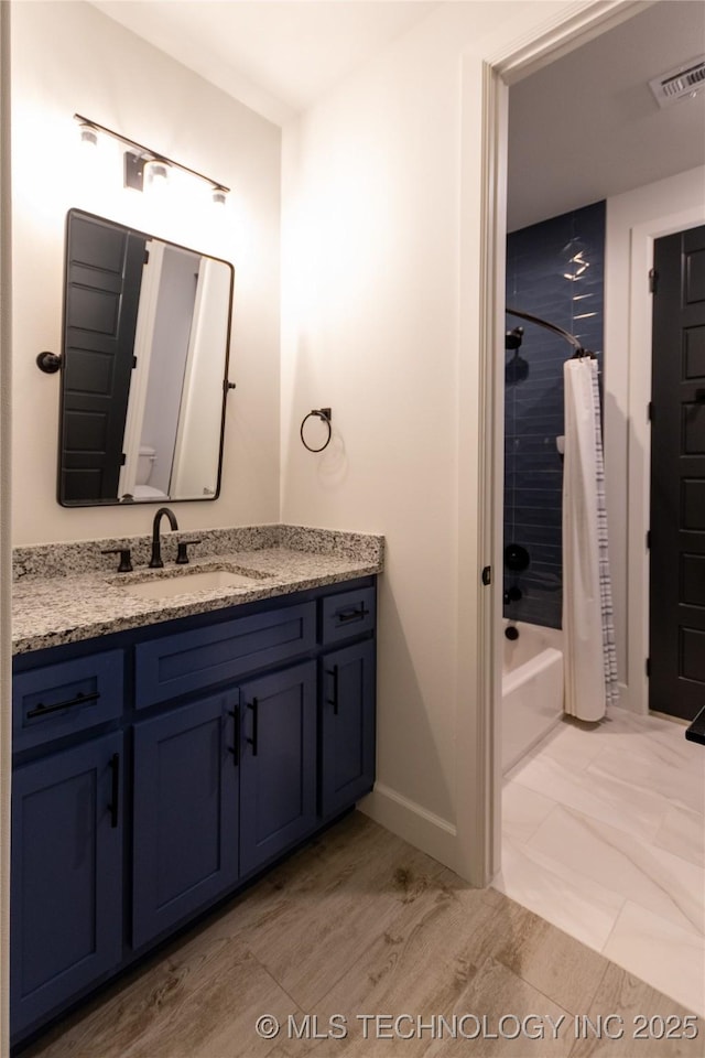 bathroom with vanity and shower / bath combo with shower curtain