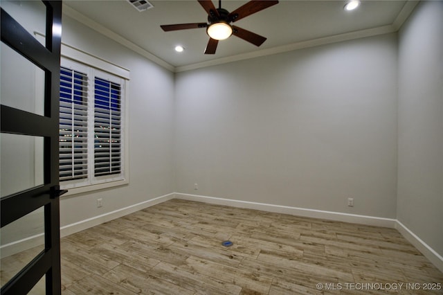 empty room with ceiling fan, crown molding, and light hardwood / wood-style flooring