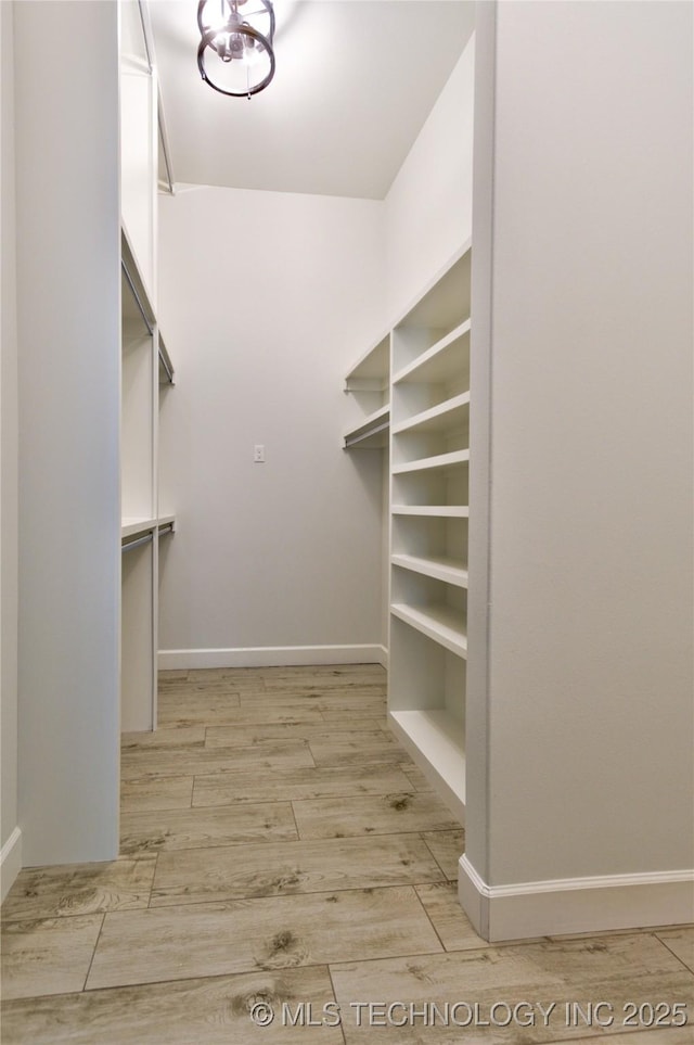 walk in closet featuring light hardwood / wood-style flooring