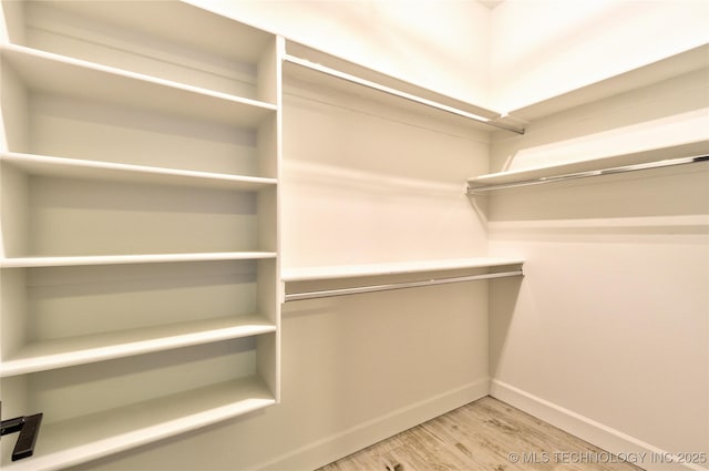 walk in closet featuring hardwood / wood-style floors