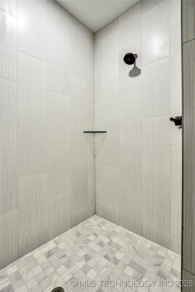 bathroom with tiled shower