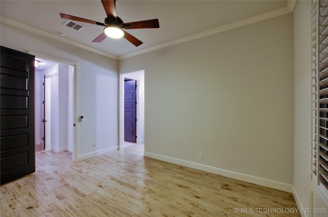 spare room featuring ceiling fan, light wood-type flooring, and ornamental molding