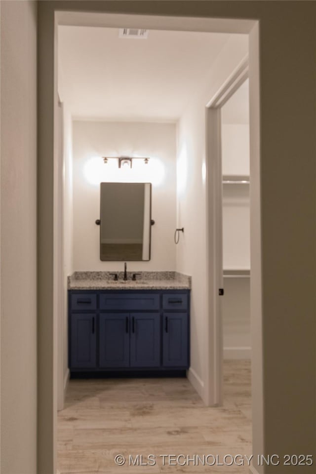 bathroom with vanity and hardwood / wood-style flooring