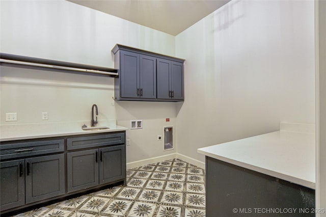 laundry area with hookup for an electric dryer, cabinets, sink, and hookup for a washing machine