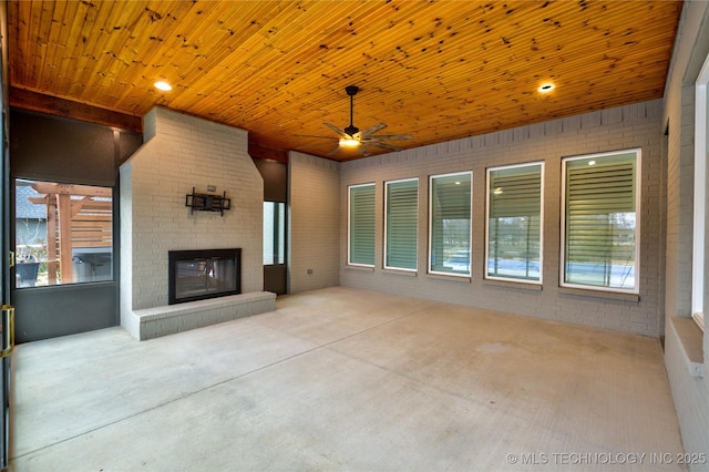 view of patio / terrace with an outdoor brick fireplace and ceiling fan