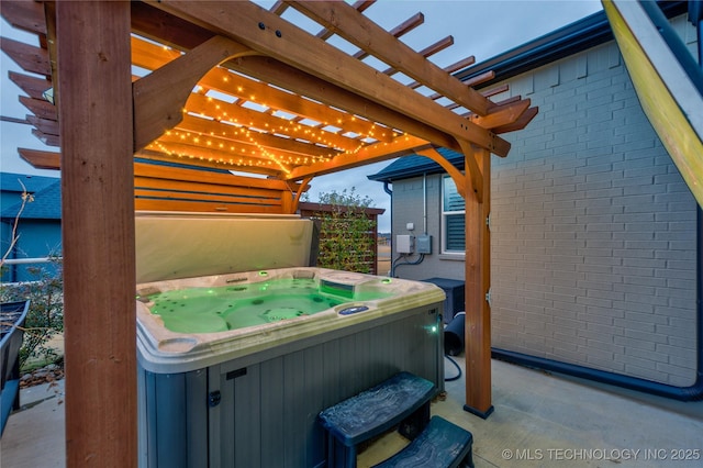 view of patio / terrace featuring a pergola and a hot tub