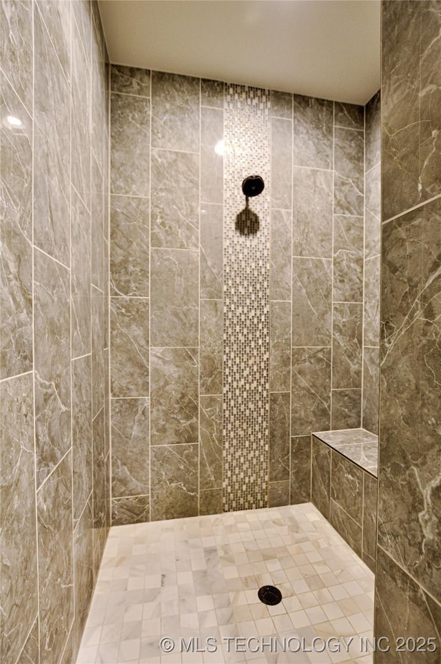 bathroom featuring a tile shower and tile walls