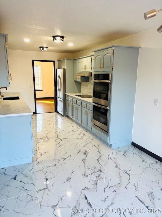 kitchen featuring appliances with stainless steel finishes, sink, and a textured ceiling