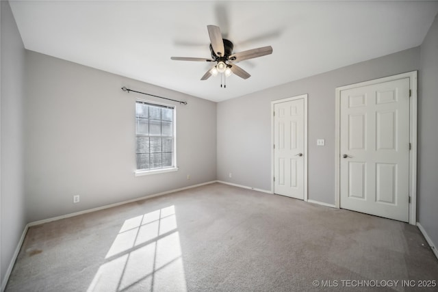 unfurnished bedroom with ceiling fan and light carpet