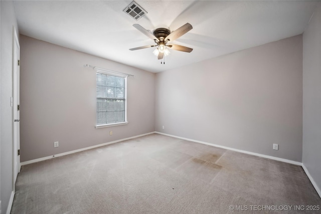 carpeted spare room with ceiling fan