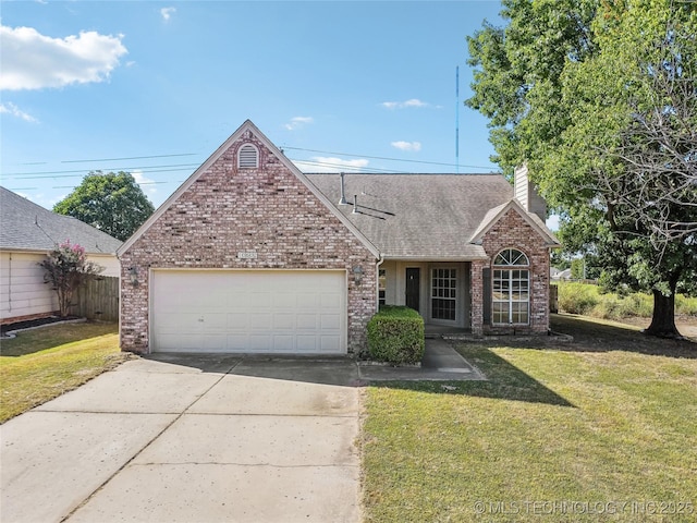 view of front facade with a garage and a front yard