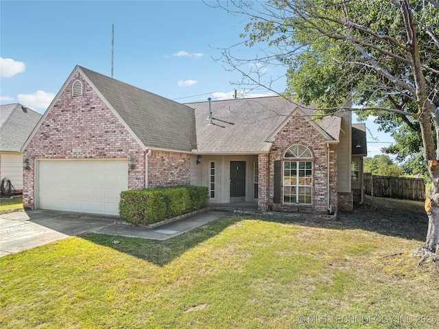 traditional-style house featuring driveway, an attached garage, a shingled roof, a front yard, and brick siding