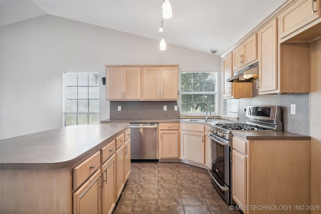 kitchen with appliances with stainless steel finishes, backsplash, vaulted ceiling, light brown cabinets, and decorative light fixtures