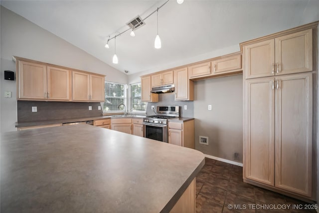 kitchen with sink, tasteful backsplash, stainless steel range with gas cooktop, vaulted ceiling, and decorative light fixtures