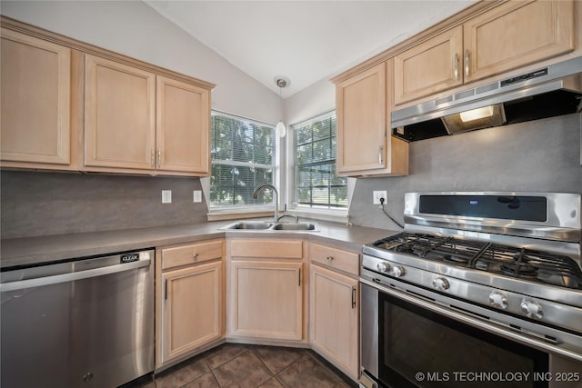 kitchen with light brown cabinets, sink, vaulted ceiling, and appliances with stainless steel finishes