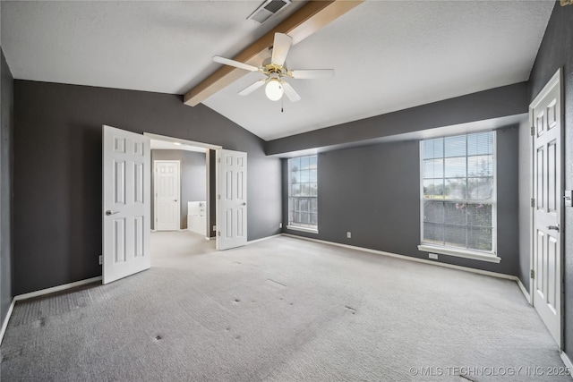 unfurnished bedroom featuring vaulted ceiling with beams, ceiling fan, light carpet, and a textured ceiling