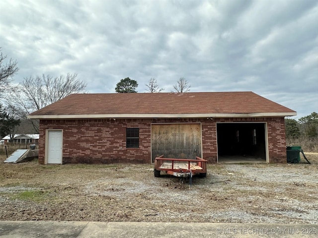 back of house featuring a garage