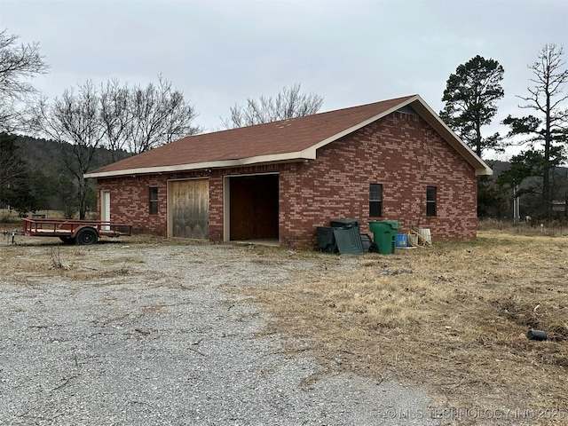 view of property exterior with an outdoor structure