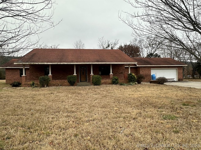 ranch-style home with a front yard and a garage