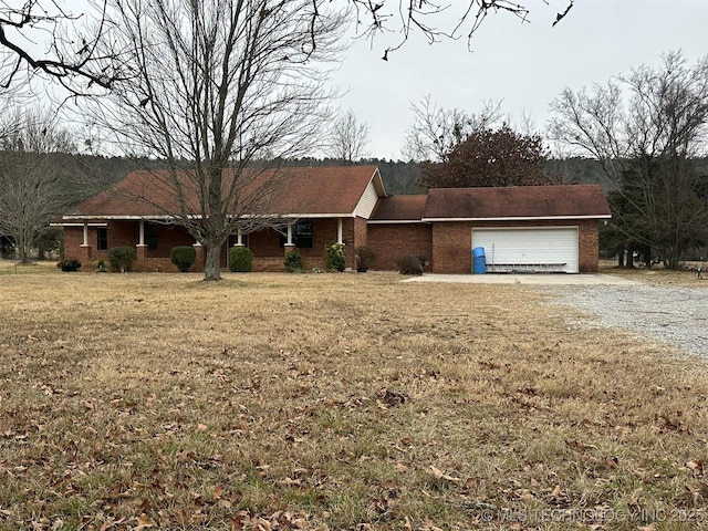 ranch-style home featuring a garage and a front yard