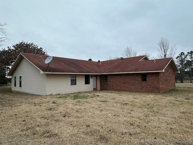 rear view of house with a yard