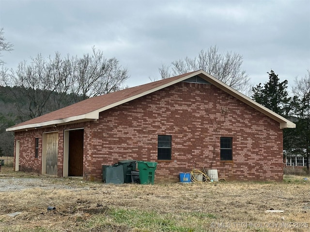 view of side of home featuring an outbuilding