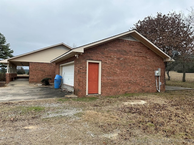 view of home's exterior with a garage and a carport