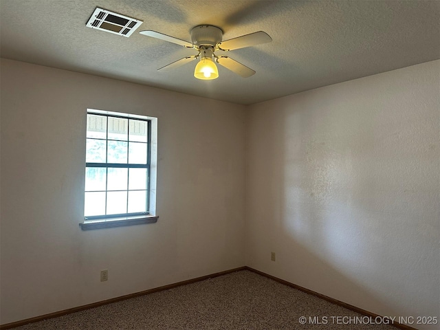 spare room with carpet flooring, a textured ceiling, and ceiling fan